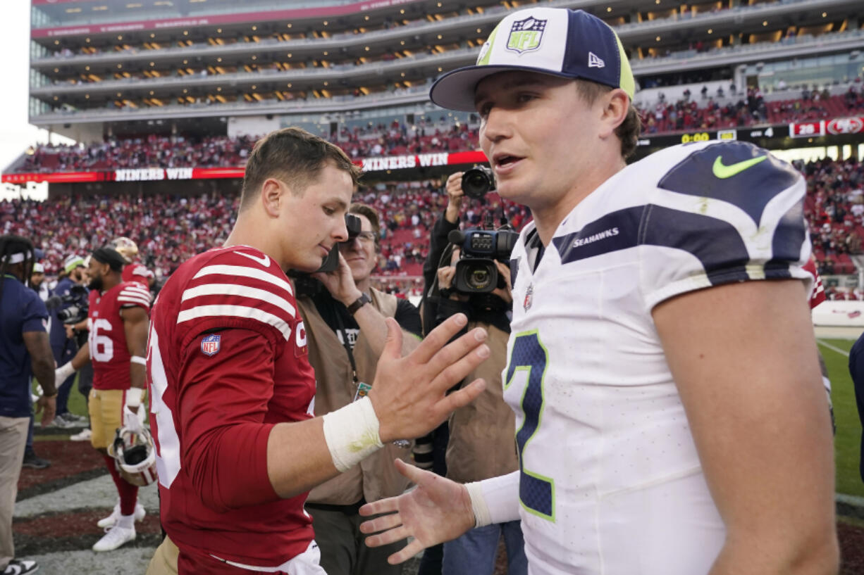 San Francisco 49ers quarterback Brock Purdy, left, greets Seattle Seahawks quarterback Drew Lock after an NFL football game in Santa Clara, Calif., Sunday, Dec. 10, 2023. (AP Photo/Godofredo A.