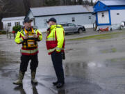 Members of the Brattleboro, Vt., Fire Department monitor the rising waters at Tri-Park Co-Op Housing as a volunteer evacuation notice was given to residents around Edgewood Drive in Brattleboro on Monday, Dec. 18, 2023.