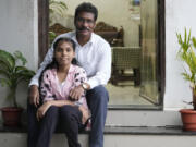 Gautam Dongre, of the National Alliance of Sickle Cell Organizations, sits for a portrait with his daughter, Sumedha, 13, at their residence in Nagpur, India, Wednesday, Dec. 6, 2023. Dongre recalls how his newborn son, Girish, cried constantly from stomach and leg pain. Doctors couldn&rsquo;t figure out what was wrong and didn&rsquo;t diagnose him with sickle cell for 2 1/2 years. When Sumedha was born, he and his wife had her tested immediately and learned she had the disease too.