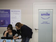 FILE - Dental assistants go over appointments at SmileDirectClub&rsquo;s SmileShop located inside a CVS store April 24, 2019, in Downey, Calif. SmileDirectClub is shutting down, just months after the struggling teeth-straightening company filed for bankruptcy, leaving existing customers in limbo. On Friday, Dec. 8, 2023, the company said it was unable to find a partner willing to bring in enough capital to keep the company afloat, despite a months-long search. (AP Photo/Jae C.