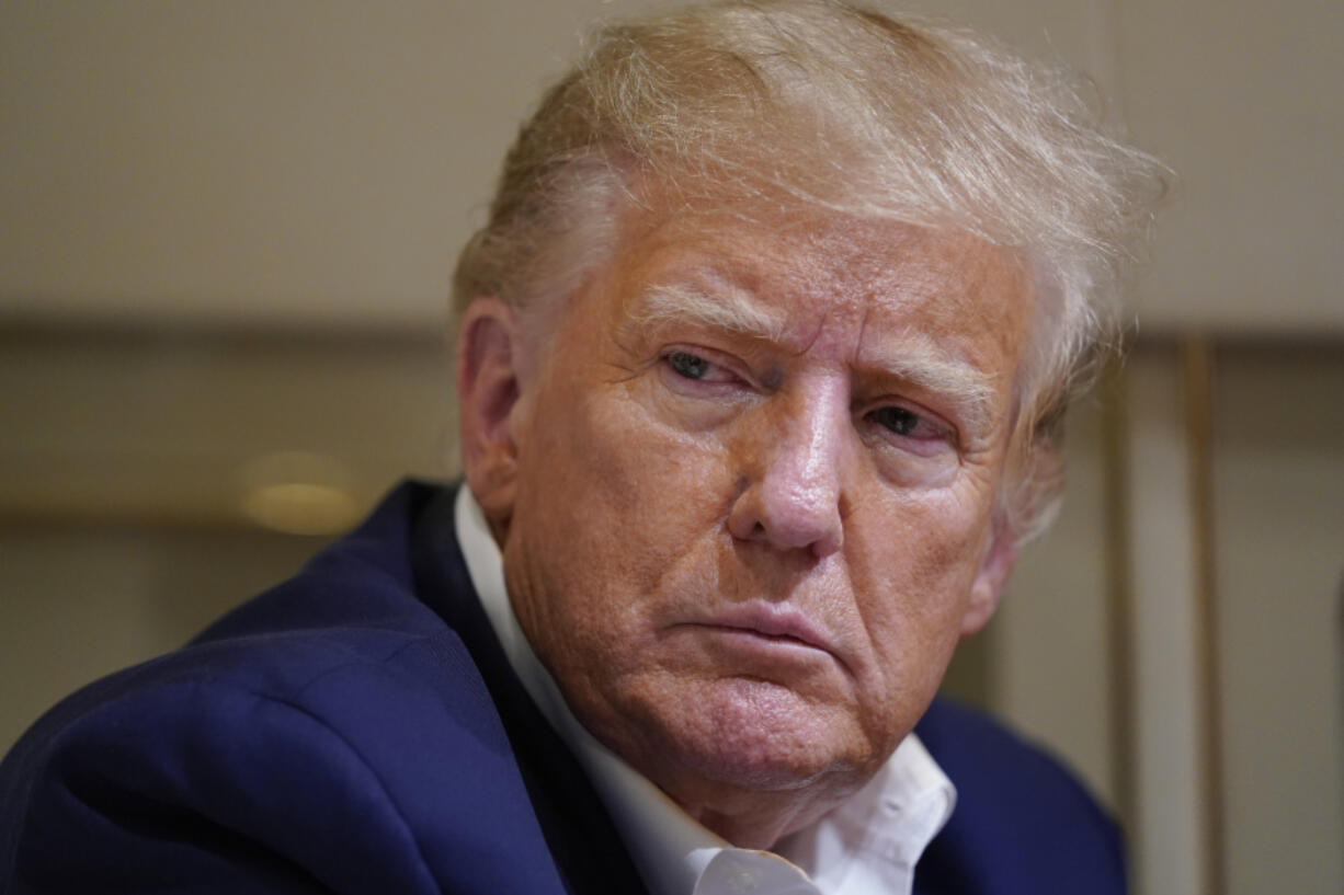 FILE - Former President Donald Trump listens as he speaks with reporters while in flight on his plane after a campaign rally at Waco Regional Airport, in Waco, Texas, March 25, 2023, while en route to West Palm Beach, Fla. The Supreme Court said Friday, Dec. 22, that it will not immediately take up a plea by special counsel Jack Smith to rule on whether former President Donald Trump can be prosecuted for his actions to overturn the 2020 election results.