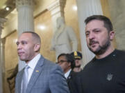 House Minority Leader Hakeem Jeffries of N.Y., left, walks with Ukrainian President Volodymyr Zelenskyy in the U.S. Capitol to a meeting with other congressional leaders, Tuesday, Dec. 12, 2023, in Washington.