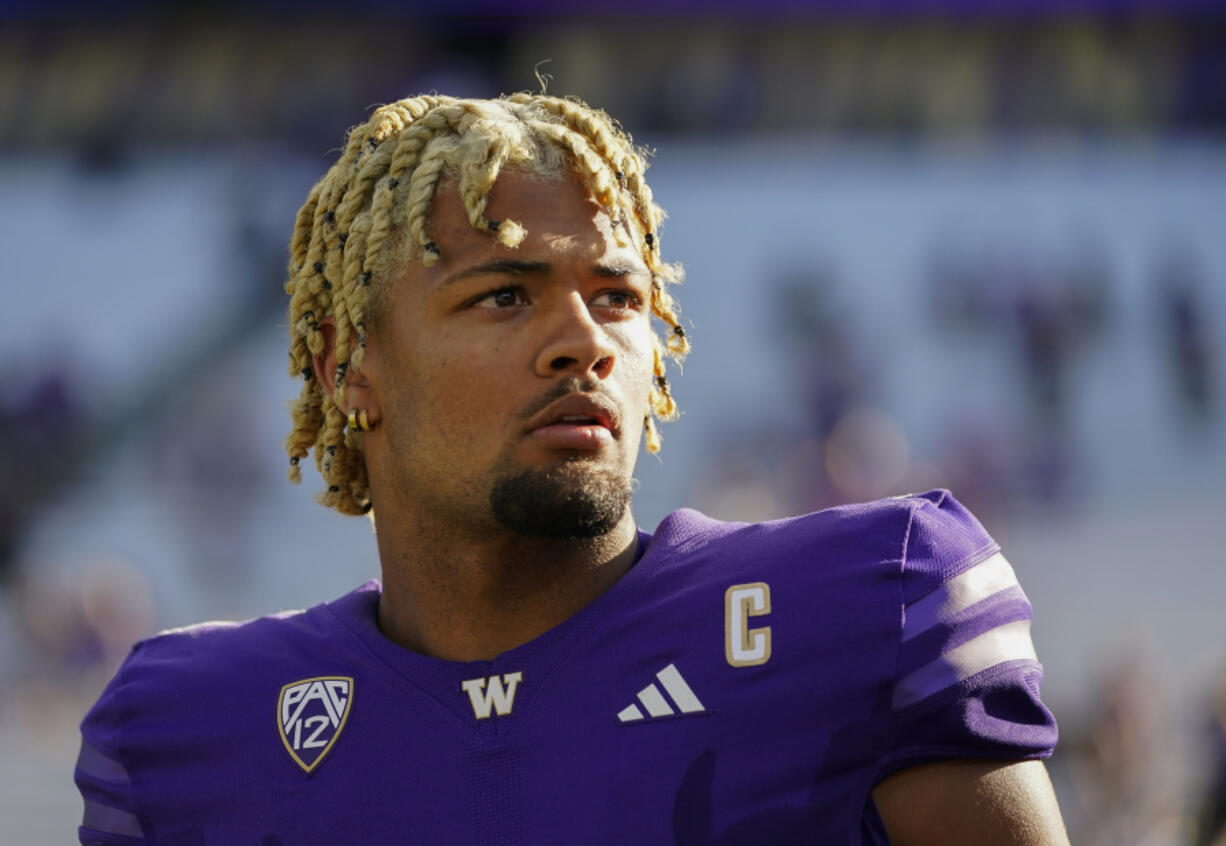 FILE - Washington wide receiver Rome Odunze looks into the stands after an NCAA college football game against Tulsa, Sept. 9, 2023, in Seattle. Odunze, who played the middle portion of the year with a broken rib and finished the year as a first-team All-American on seemingly every list, will face No. 3 Texas in the Sugar Bowl Monday, Jan. 1, 2024.