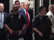 Former President Donald Trump is escorted to a courtroom in New York on April 4, 2023. Trump is accused of falsifying internal business records at his private company while trying to cover up an effort to illegally influence the 2016 election by arranging payments that silenced claims potentially harmful to his candidacy.