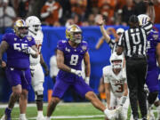 Washington defensive end Bralen Trice (8) celebrates during the second half of the Sugar Bowl CFP NCAA semifinal college football game against Texas, Monday, Jan. 1, 2024, in New Orleans.