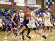 Ridgefield’s Jamison McCann drives toward the basket during a 2A Greater St. Helens League boys basketball game against Columbia River on Thursday, Jan. 4, 2024, at Ridgefield High School.