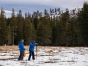 Sean de Guzman, right, snow survey manager at the Department of Water Resources, conducts the first snow survey of the season Jan. 2 with his team at Phillips Station in El Dorado County, Calif.