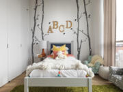 Wall decor such as letters and wall stickers help to add an element of whimsy in this children&rsquo;s bedroom.