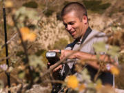 Amateur botanist Matt Smith sets up a flash to photograph a Davidson&rsquo;s bushmallow plant in the Big Tujunga Canyon in Sunland, Calif.