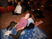 Participants pair up and fall back on each other during The Feels event on a recent December evening.