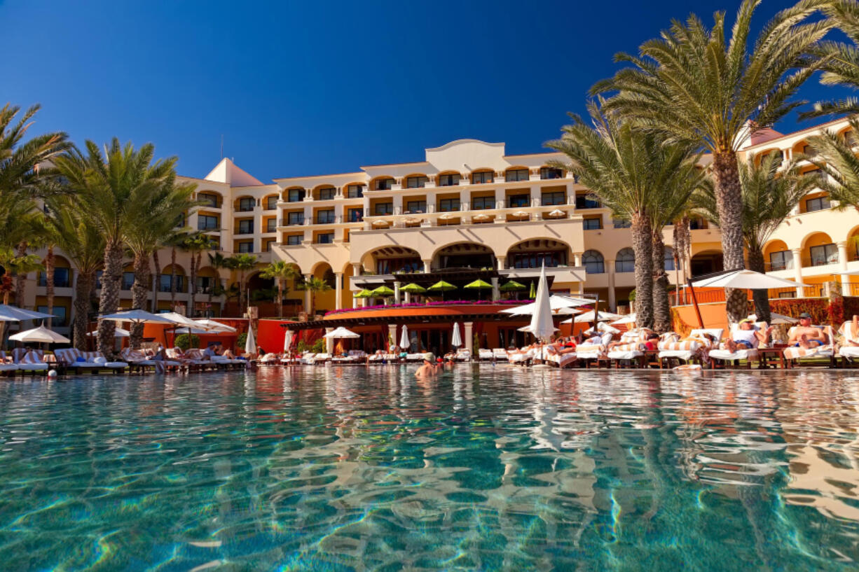 Tourists relax at a resort poolside in Cabo San Lucas, Mexico.