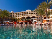 Tourists relax at a resort poolside in Cabo San Lucas, Mexico.