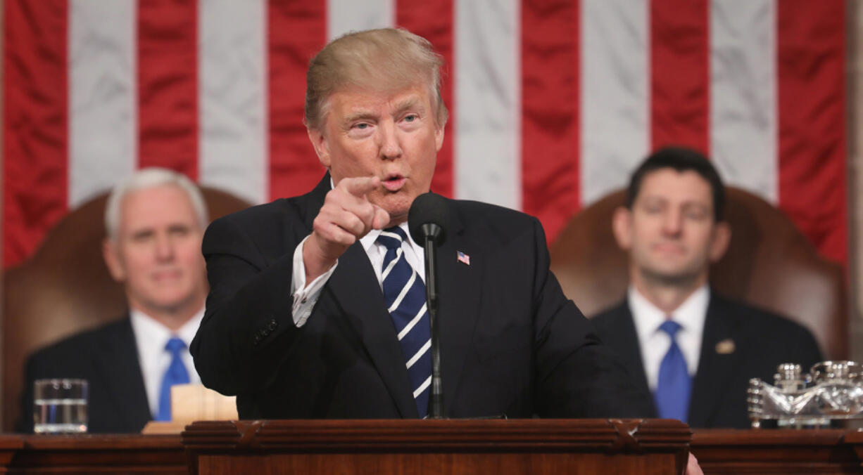 U.S. President Donald J. Trump (center) delivers his first address to a joint session of the U.S. Congress as U.S. Vice President Mike Pence (left) and Speaker of the House Paul Ryan (right) listen on Feb. 28, 2017, in the House chamber of the U.S. Capitol in Washington, DC. Trump&rsquo;s first address to Congress is expected to focus on national security, tax and regulatory reform, the economy, and healthcare.