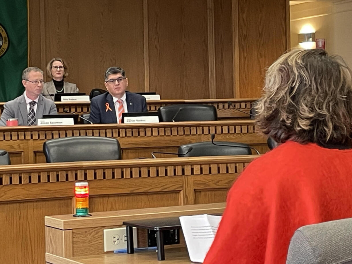 Democratic state Sens. Jesse Salomon (l) and Javier Valdez listen to a supporter of Valdez&rsquo;s bill to bar open-carry of firearms in public parks and libraries on Jan. 15, 2024.