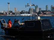 Muckleshoot fishermen Dezi Louie, wearing red, and Levi Hamilton join other tribal boats for a chum opening on Elliott Bay. Their ancestors could never have imagined this cityscape, but they knew when signing the treaty with the U.S. that their people would need to be able to continue to travel to hunt, fish and gather as they always have. The treaty right to fish was insisted on by tribes when pressed to sign treaties with the U.S. in 1855 that cleared the way for white settlement.