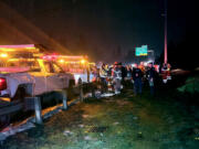 The scene of a Sunday night crash in which a Chevrolet Impala, driven by a suspected drunk driver, rear-ended a Washington State Department of Transportation truck, pushing it into another truck on the shoulder of Interstate 5 near Milepost 8. All six of the road workers who were injured in the crash were discharged from hospitals by Monday afternoon.