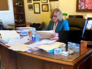 State Sen. Annette Cleveland, D-Vancouver, from the 49th Legislative District, uses the time between committee meetings to talk with constituents, lobbyists and fellow lawmakers in her Olympia office Tuesday.