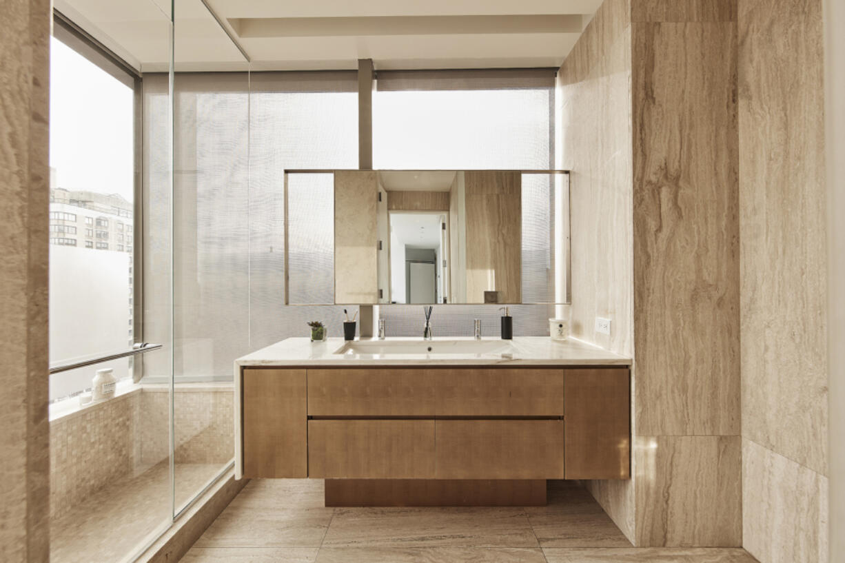 A wall hung vanity provides a neutral complete to an all tile master bathroom.