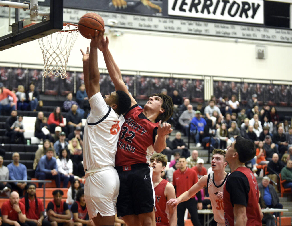 Union’s Nick Burchett (32) blocks a Battle Ground shot attempt during a 4A Greater St. Helens League boys basketball game on Tuesday, Jan. 30, 2024, at Battle Ground High School.