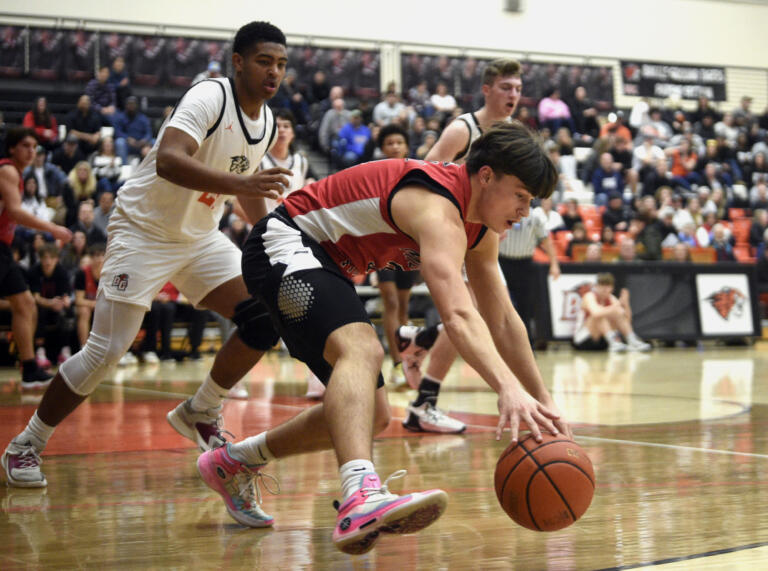 Union’s Grayson Stanley reaches down to retrieve a loose ball in the backcourt during a 4A GSHL boys basketball game against Battle Ground on Tuesday, Jan. 30, 2024, at Battle Ground High School.