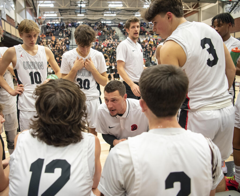 Union head coach Garold Howe, center, talks to the team Tuesday, Jan. 2, 2024, during the Titans’ 71-33 loss to Camas at Union High School.