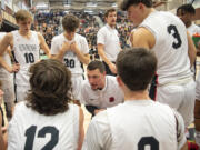 Union head coach Garold Howe, center, talks to the team Tuesday, Jan. 2, 2024, during the Titans’ 71-33 loss to Camas at Union High School.