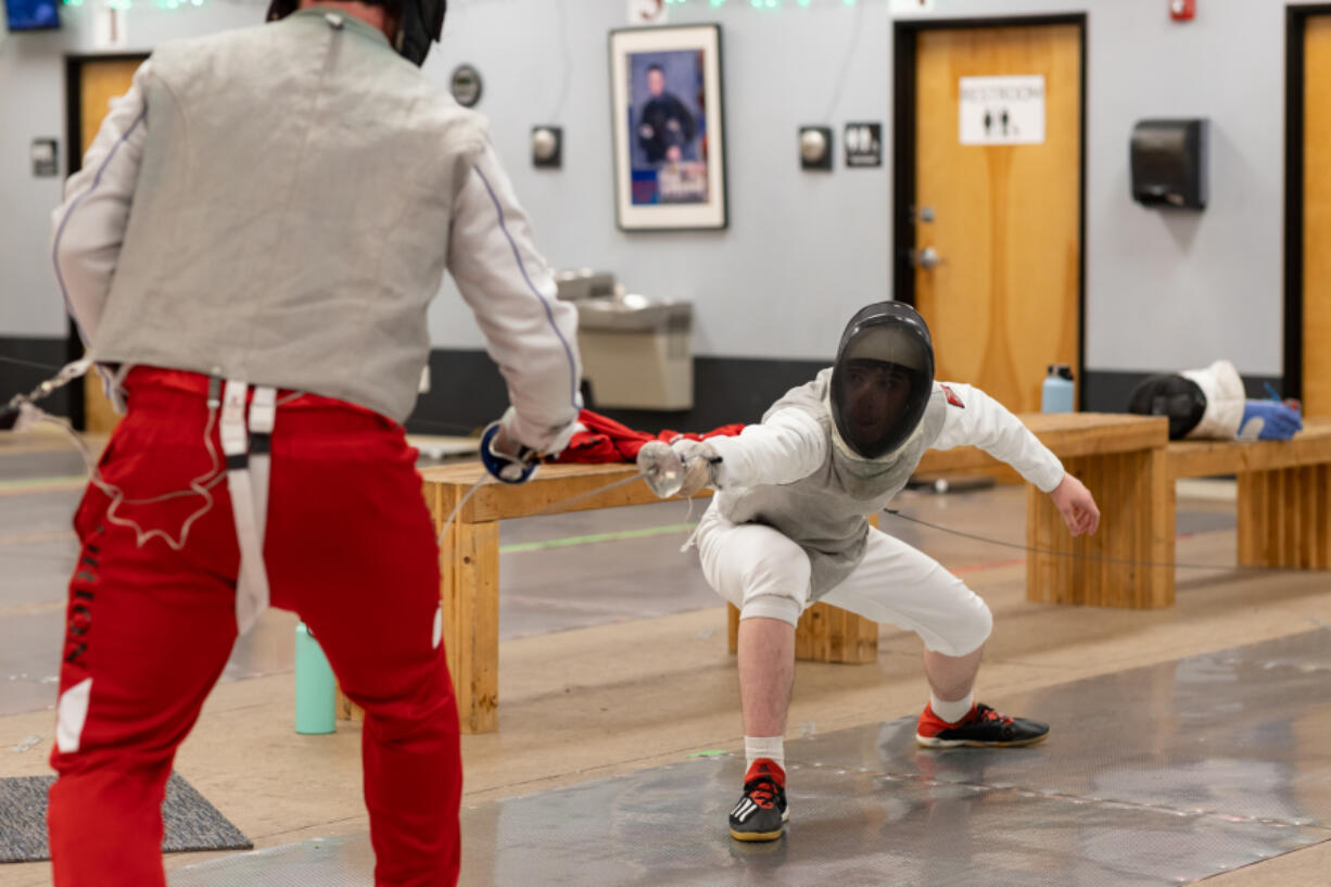 Student London Lockwood lunges for an attack during practice Dec. 11.