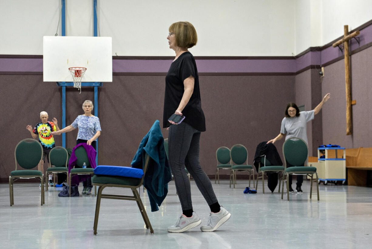 Fitness instructor Barbara Dunlap, center, leads local seniors in an hourlong strength-and-balance class called Enhance Fitness, sponsored by the Area Agency on Aging &amp; Disability of Southwest Washington, at Bethel Lutheran Church in Brush Prairie.