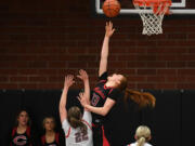 Camas senior Addison Harris (33) shoots a reverse layup while being defending by Union junior Addy Eisfeldt (22) in the 4A Greater St. Helens League game Tuesday. Harris scored 17 points to go with nine rebounds and two blocked shots during the Papermakers&rsquo; 65-43 win at Union High School.