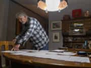 Woodland East Mobile Home Park resident Jim Schulze looks over the various rent increase notices he has received Wednesday in Woodland.