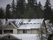 A light blanket of snow is seen on rooftops in Salmon Creek on Wednesday morning, Jan. 10, 2024.