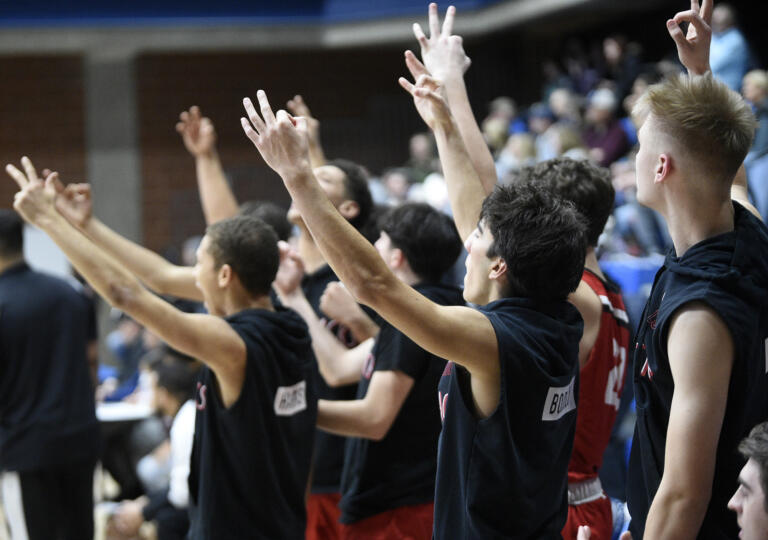 The R.A. Long bench celebrates a a three-point shot during the Lumberjacks’ 67-47 win over Hockinson in a 2A Greater St. Helens League boys basketball game at Hockinson High School on Thursday, Jan. 11, 2024.