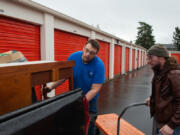 James Rexroad/for The Columbian
Connor Murphy of Connor&rsquo;s Hauling Service, left, along with his helper, Ben Reese of Vancouver,  empty a storage unit.