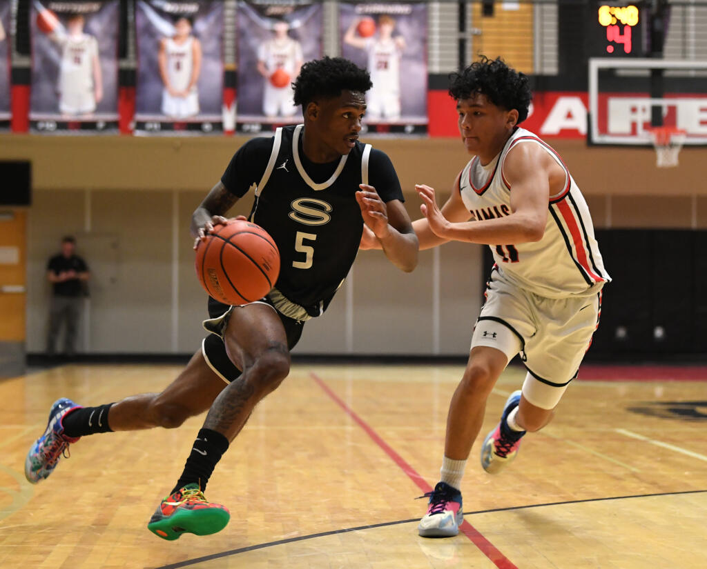 Skyview senior Demaree Collins, left, dribbles against Camas junior Nyima Namru on Tuesday, Jan. 23, 2024, during the Storm’s 69-66 loss to Camas at Camas High School.