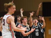 Skyview players celebrate a basket Tuesday, Jan. 23, 2024, during the Papermakers’ 69-66 win against Skyview at Camas High School.