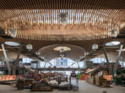 In a sense, the main terminal&rsquo;s new roof is one of the world&rsquo;s largest wooden puzzles. It can be separated into 20 individual pieces which were moved from the fabrication yard, located three-quarters of a mile down the tarmac, to the main terminal. Each piece weighs at least 600,000 pounds and took four nights to be moved into place. (Photos by Stephen A.