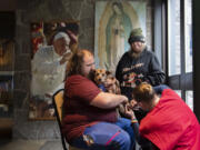 Josiah Rhodes of Vancouver, from left, comforts his four-legged friend, Molly, as she gets a free toenail trim from Christy Gifford of Humane Society for Southwest Washington during Project Homeless Connect Thursday morning at St. Joseph Catholic Church in Vancouver. Rhodes&rsquo; aunt, Cheri Rhodes, watches nearby. The event is the largest resource fair for homeless people in Clark County.