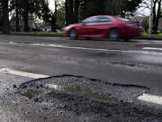 Potholes form when ice, snow or rain seeps into asphalt pavement through cracks. The moisture beneath the surface expands when temperatures drop. When it drains, a gap forms underneath the pavement, which crumbles into a pothole when a vehicle drives over it.