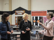 Rep. Marie Gluesenkamp Perez, from left, pauses to chat with Washougal School District Superintendent Mary Templeton and Margaret Rice, career and technical education director, at Washougal High School on Jan. 24.