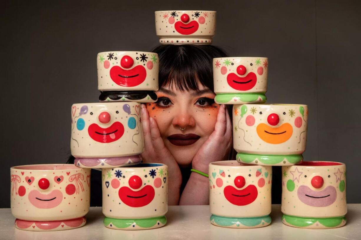 Soraya Yousefi poses with her bowls and cups. &ldquo;I&rsquo;m such a maximalist,&rdquo; she said. &ldquo;I hate empty space, including on my own face, so I&rsquo;ve always had doodles around my face and little dots.