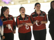 Fort Vancouver bowlers, from left, Annabelle Wiley, Lacey McHan and Lilly Peschka celebrate along with coach Lauryn Heying (far right) after placing third at the 2A girls bowling district tournament at Triangle Bowl in Longview on Friday, Jan. 26, 2024.