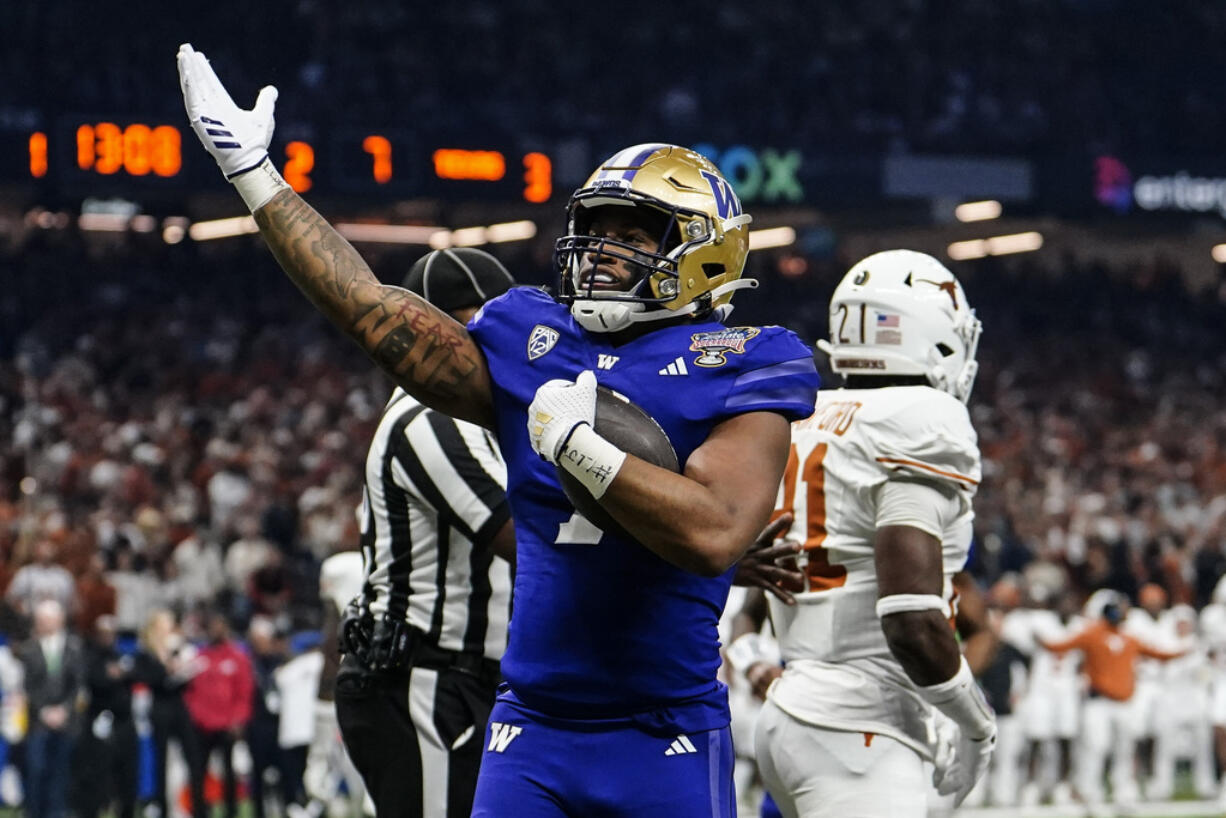 Washington running back Dillon Johnson (7) celebrates his touchdown against Texas during the first half of the Sugar Bowl CFP NCAA semifinal college football game, Monday, Jan. 1, 2024, in New Orleans.