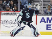 Seattle Kraken goaltender Joey Daccord (35) reaches up to catch a high shot by a Ottawa Senators player during the first period of an NHL hockey game, Thursday, Jan. 4, 2024, in Seattle.