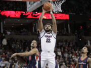 Gonzaga forward Anton Watson (22) shoots next to Pepperdine forward Jevon Porter, left, during the second half of an NCAA college basketball game Thursday, Jan. 4, 2024, in Spokane, Wash.