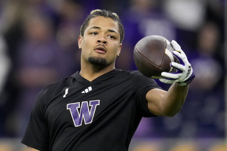 Washington wide receiver Rome Odunze warms up before the national championship NCAA College Football Playoff game between Washington and Michigan Monday, Jan. 8, 2024, in Houston. (AP Photo/Godofredo A.