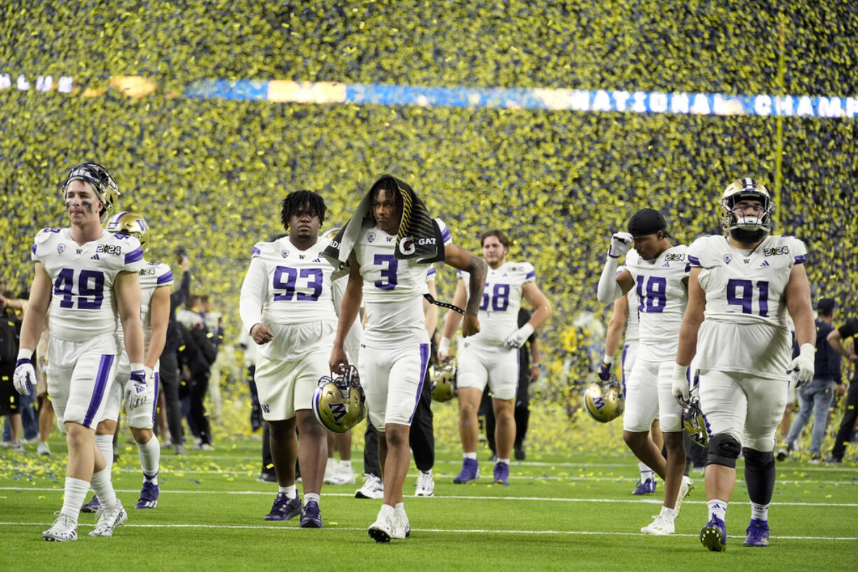 Washington leaves the field after their loss against Michigan in the national championship NCAA College Football Playoff game Monday, Jan. 8, 2024, in Houston.