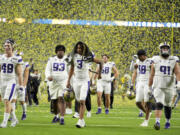 Washington leaves the field after their loss against Michigan in the national championship NCAA College Football Playoff game Monday, Jan. 8, 2024, in Houston.
