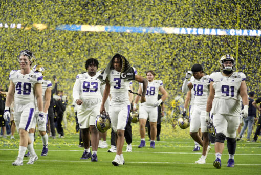 Washington leaves the field after their loss against Michigan in the national championship NCAA College Football Playoff game Monday, Jan. 8, 2024, in Houston. (AP Photo/Eric Gay)