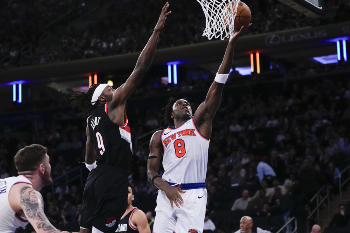 New York Knicks' OG Anunoby (8) drives past Portland Trail Blazers' Jerami Grant (9) during the second half of an NBA basketball game Tuesday, Jan. 9, 2024, in New York. The Knicks won 112-84.