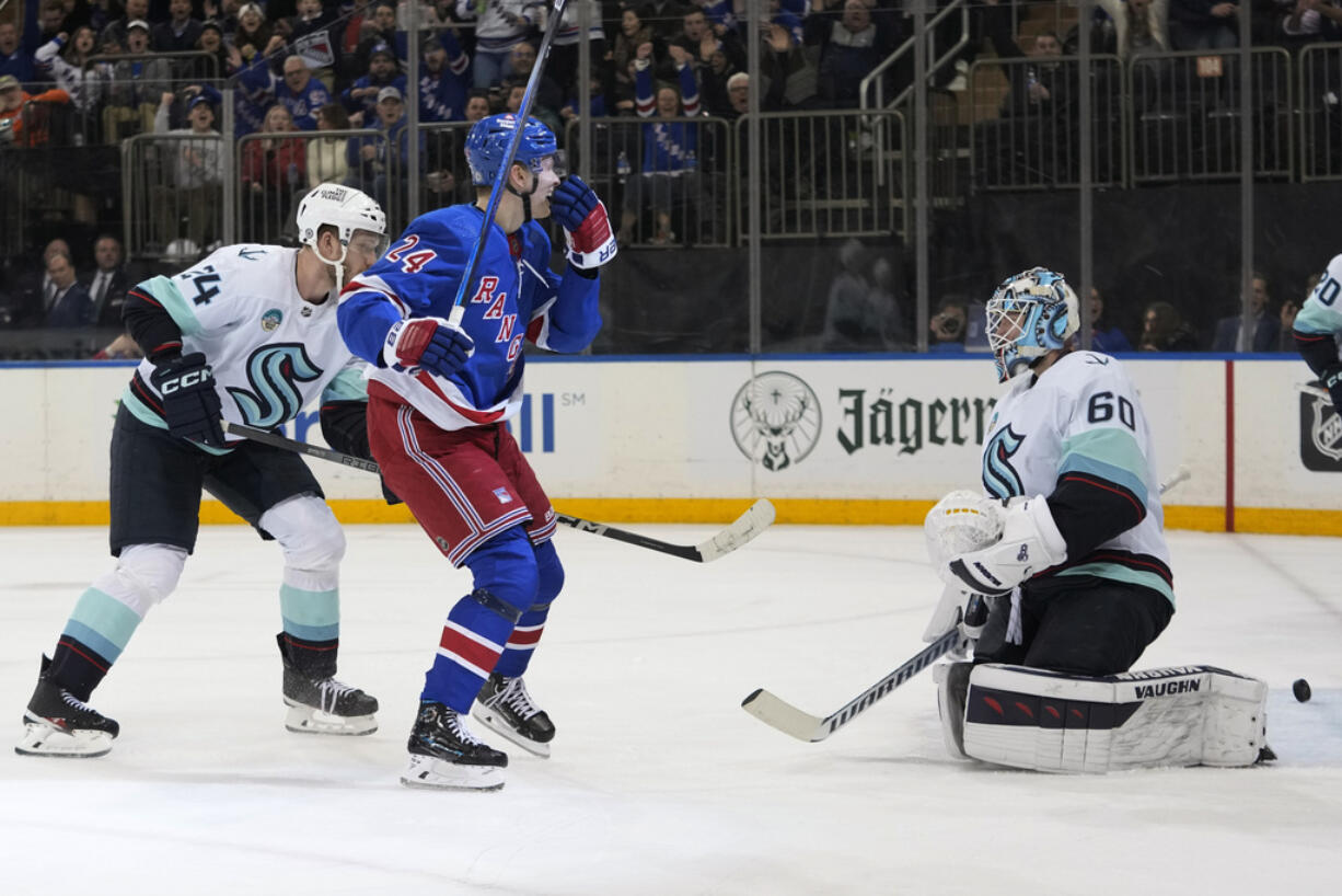 New York Rangers right wing Kaapo Kakko (24) reacts after scoring against Seattle Kraken goaltender Chris Driedger (60) during the second period of an NHL hockey game Tuesday, Jan. 16, 2024, at Madison Square Garden in New York.